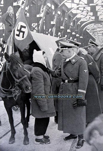 Reichsführer-SS Heinrich Himmler with ethnic Germans returning to Nazi Germany